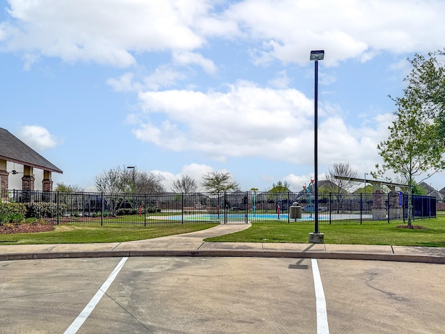 1415 Nacogdoches Valley Dr, League City, TX 77573 - view of car parking with a swimming pool and fence
