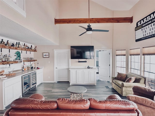 395 Redfish Dr, Freeport, TX 77541 - living area featuring high vaulted ceiling, a bar, wine cooler, ceiling fan, and dark wood-style floors