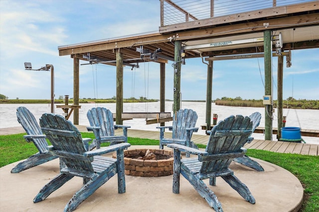 395 Redfish Dr, Freeport, TX 77541 - view of patio / terrace featuring a fire pit and a water view