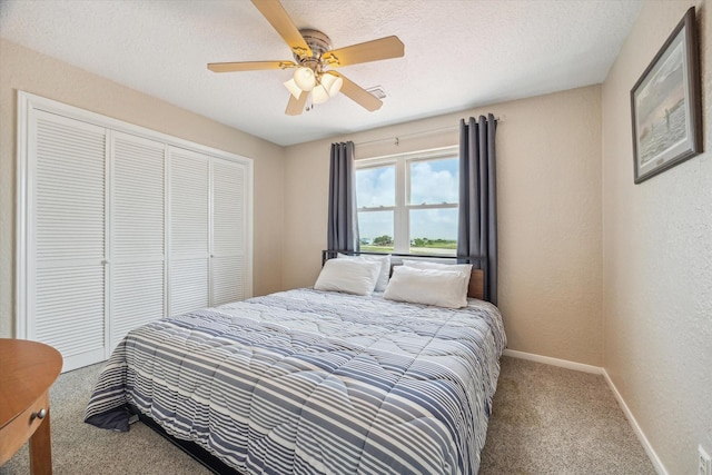 395 Redfish Dr, Freeport, TX 77541 - bedroom featuring carpet floors, baseboards, a closet, a ceiling fan, and a textured wall