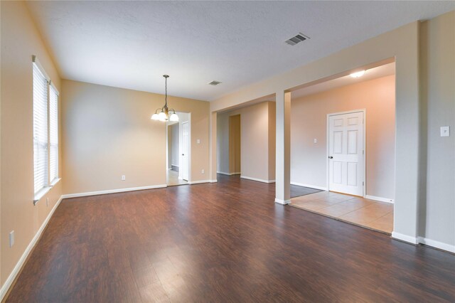 18015 Secret Branch Ln, Cypress, TX 77433 - spare room featuring wood finished floors, a chandelier, and baseboards