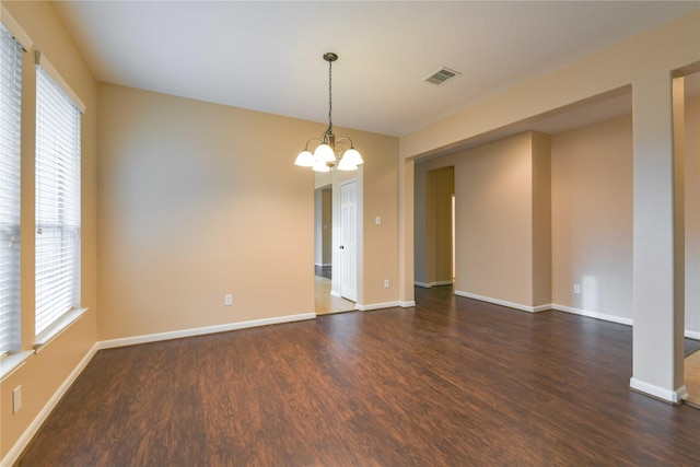 18015 Secret Branch Ln, Cypress, TX 77433 - empty room featuring dark wood finished floors, a chandelier, and baseboards