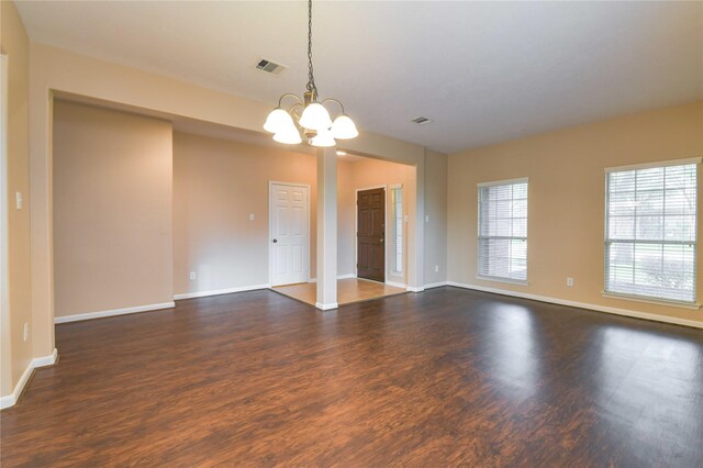 18015 Secret Branch Ln, Cypress, TX 77433 - spare room with dark wood-type flooring, a chandelier, and baseboards
