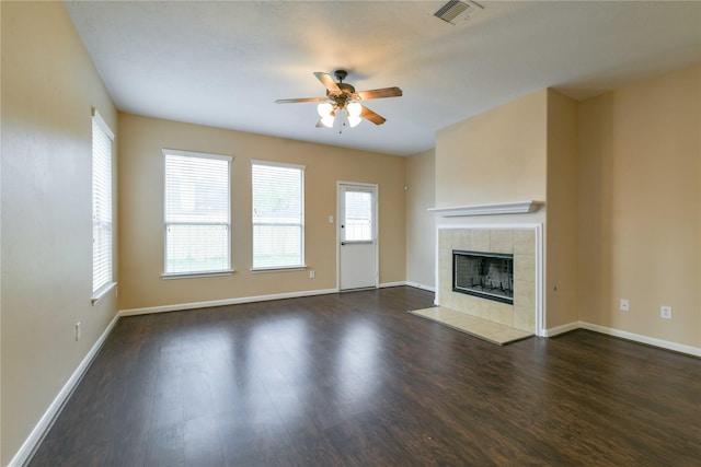 18015 Secret Branch Ln, Cypress, TX 77433 - unfurnished living room with ceiling fan, a tile fireplace, wood finished floors, and baseboards