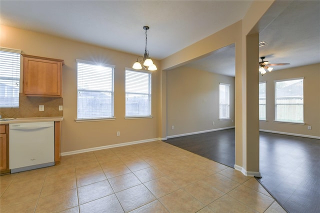 18015 Secret Branch Ln, Cypress, TX 77433 - kitchen with dishwasher, a ceiling fan, open floor plan, light countertops, and a chandelier
