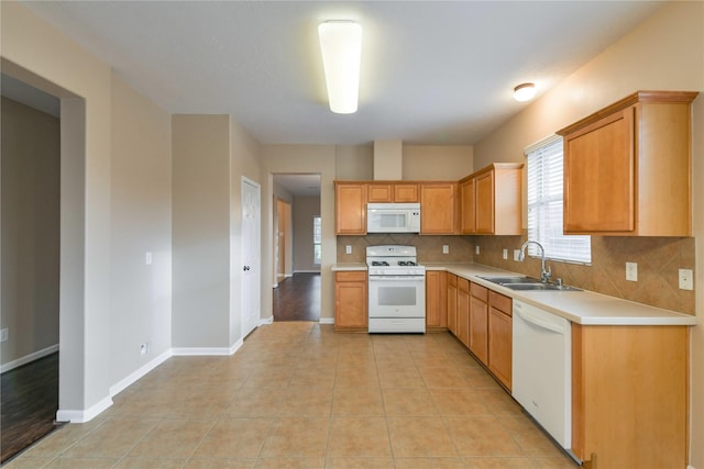 18015 Secret Branch Ln, Cypress, TX 77433 - kitchen featuring white appliances, a sink, plenty of natural light, and tasteful backsplash