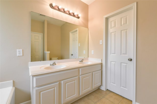 18015 Secret Branch Ln, Cypress, TX 77433 - bathroom featuring double vanity, tile patterned flooring, and toilet