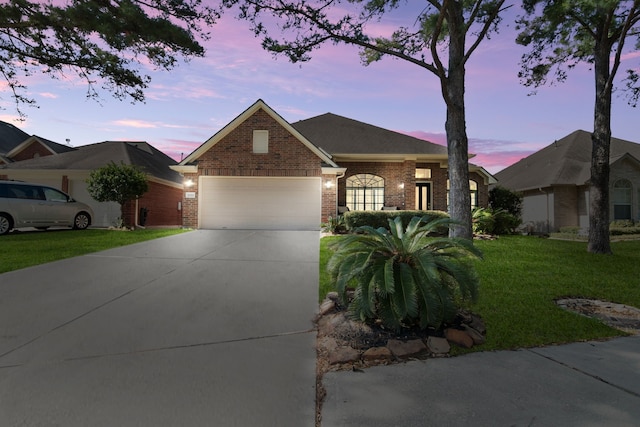 11910 Canyon Star Ln, Tomball, TX 77377 - view of front facade featuring brick siding, concrete driveway, a garage, and a front lawn