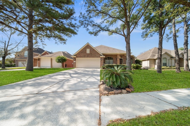 11910 Canyon Star Ln, Tomball, TX 77377 - view of front of house featuring brick siding, a garage, concrete driveway, and a front yard