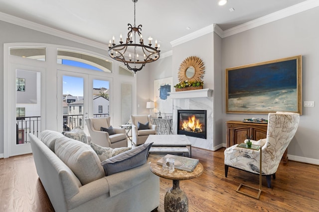 308 W Saulnier St, Houston, TX 77019 - living area featuring ornamental molding, a chandelier, and wood finished floors