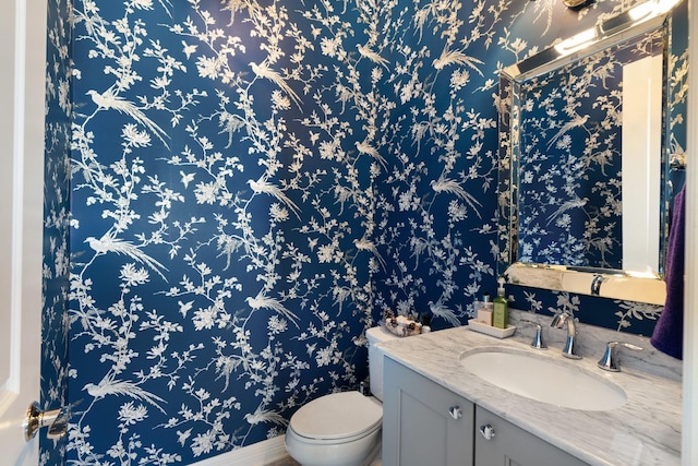 308 W Saulnier St, Houston, TX 77019 - half bathroom with toilet, vanity, and wallpapered walls