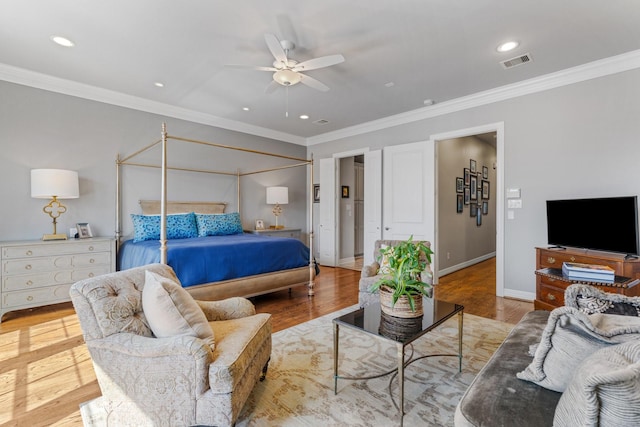 308 W Saulnier St, Houston, TX 77019 - bedroom with baseboards, visible vents, wood finished floors, and ornamental molding