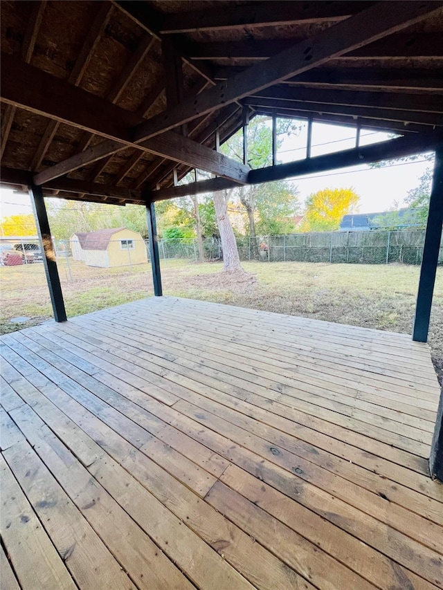 dock area with a wooden deck, a yard, and a fenced backyard