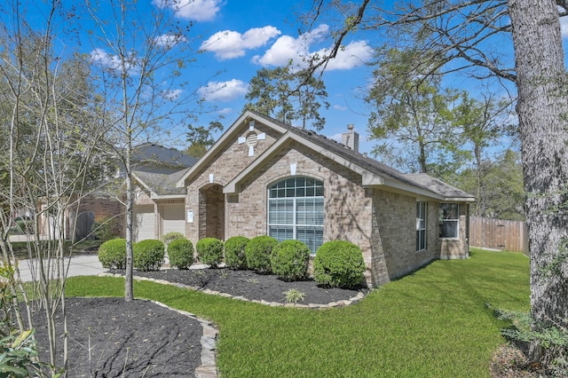 82 S Regan Mead Cir, Montgomery, TX 77382 - view of home's exterior with brick siding and a chimney