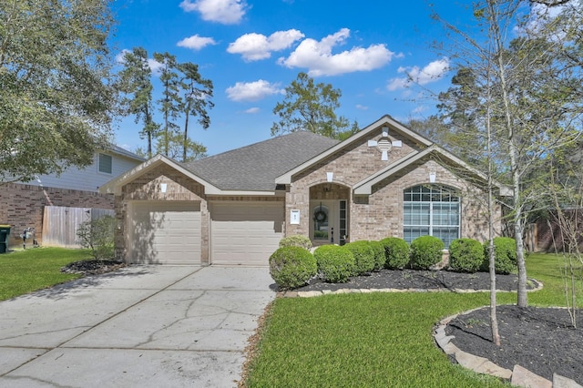 82 S Regan Mead Cir, Montgomery, TX 77382 - view of front of home featuring an attached garage, concrete driveway, brick siding, and roof with shingles