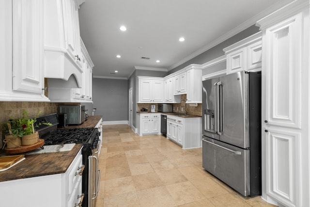 8536 Prince William Ct, Montgomery, TX 77316 - kitchen featuring stainless steel appliances, wooden counters, a sink, backsplash, and recessed lighting