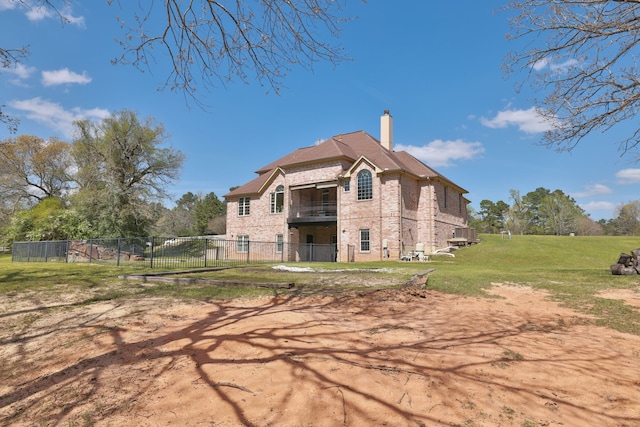 8536 Prince William Ct, Montgomery, TX 77316 - rear view of house featuring a balcony, a chimney, and brick siding