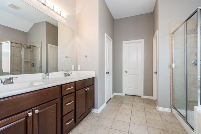 17823 Dappled Walk Way, Cypress, TX 77429 - bathroom with a shower stall, double vanity, and tile patterned floors