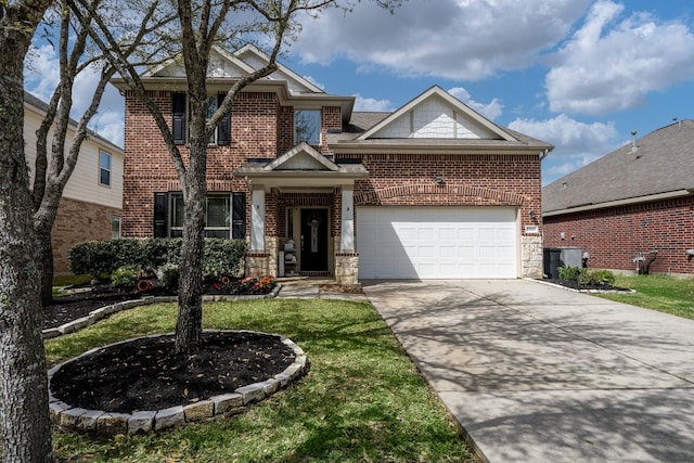 view of front facade with driveway, stone siding, an attached garage, a front yard, and brick siding