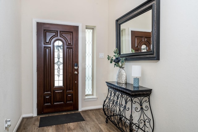 entryway featuring wood finished floors and baseboards