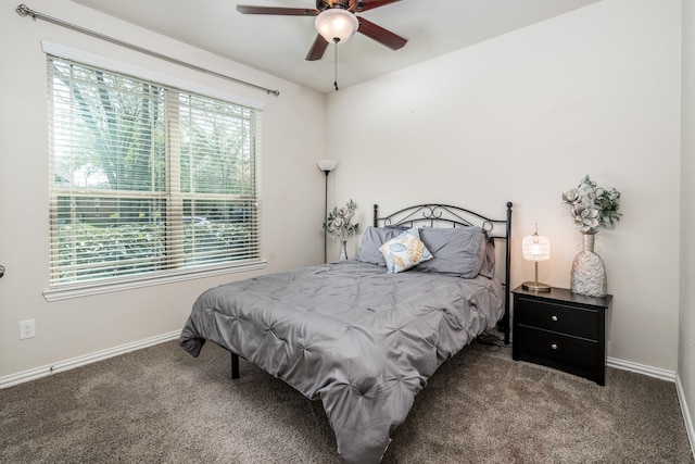 carpeted bedroom featuring a ceiling fan and baseboards