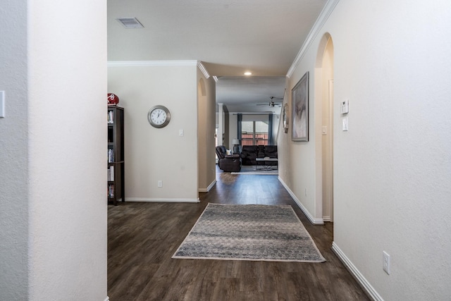 hall with recessed lighting, dark wood-style floors, ornamental molding, arched walkways, and baseboards