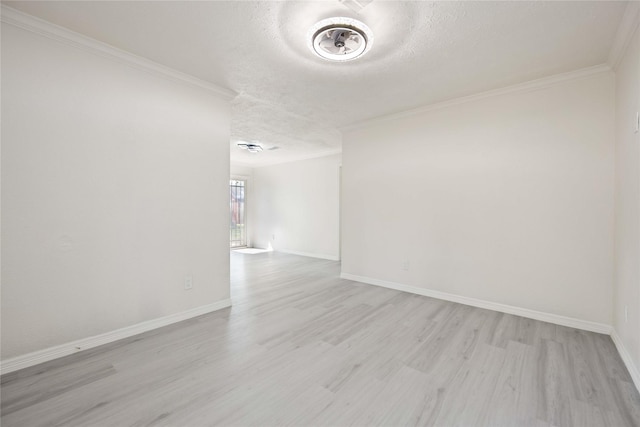 empty room featuring crown molding, a textured ceiling, and light wood-type flooring