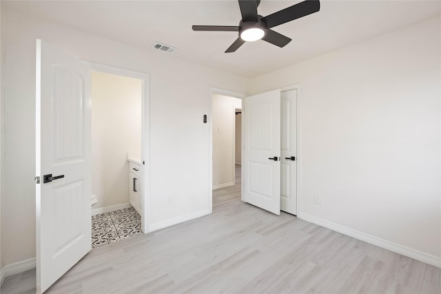 unfurnished bedroom with light wood finished floors, visible vents, and baseboards