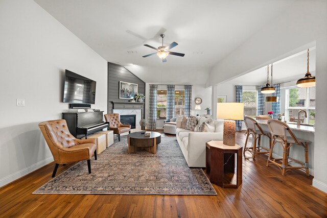 4738 Trickle Creek Ct, Fulshear, TX 77441 - living area with hardwood / wood-style floors, a high end fireplace, baseboards, a ceiling fan, and vaulted ceiling