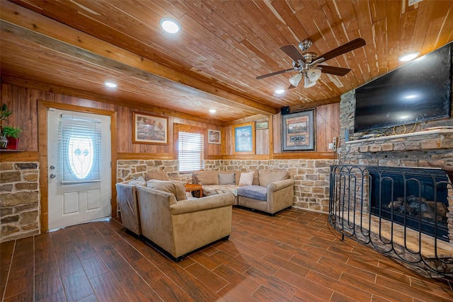 6009 Crane St, Houston, TX 77026 - living room with a ceiling fan, a stone fireplace, wood finished floors, wooden ceiling, and wood walls
