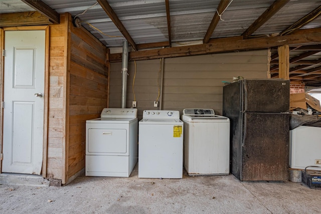 6009 Crane St, Houston, TX 77026 - laundry room featuring wooden walls, washing machine and clothes dryer, and laundry area