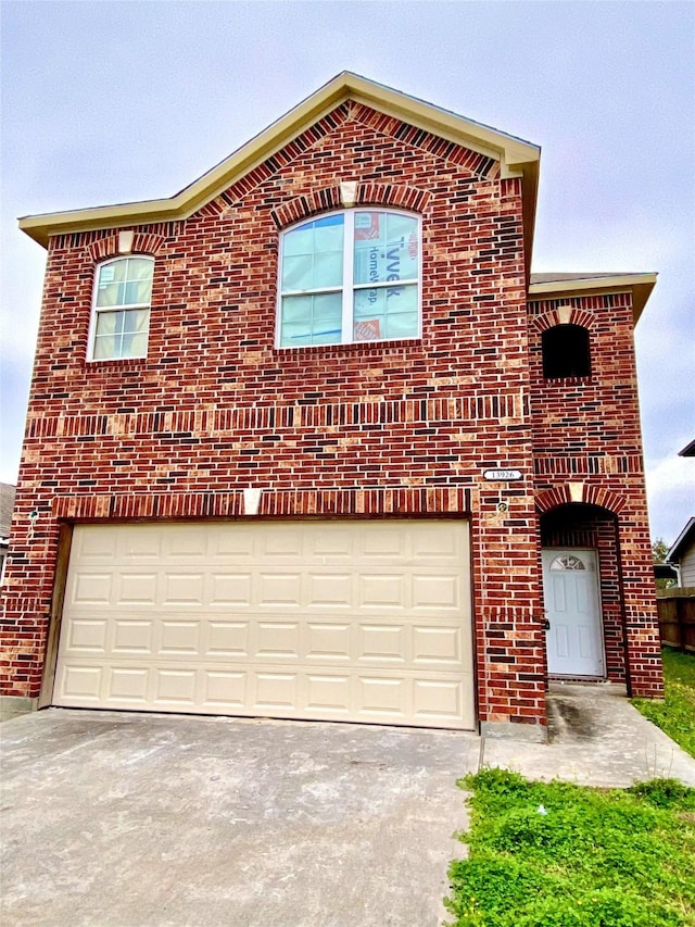 13926 Leabrandon Ln, Houston, TX 77045 - view of front of home featuring brick siding, concrete driveway, and a garage