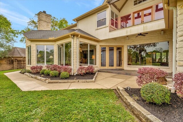 2023 Greenwood Oaks Dr, Houston, TX 77062 - back of property with a lawn, ceiling fan, a chimney, and a shingled roof