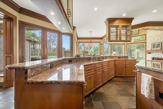 2023 Greenwood Oaks Dr, Houston, TX 77062 - kitchen featuring stone tile floors, plenty of natural light, and ornamental molding