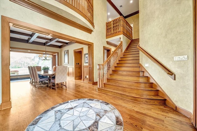 2023 Greenwood Oaks Dr, Houston, TX 77062 - staircase with a chandelier, beam ceiling, a high ceiling, wood finished floors, and coffered ceiling
