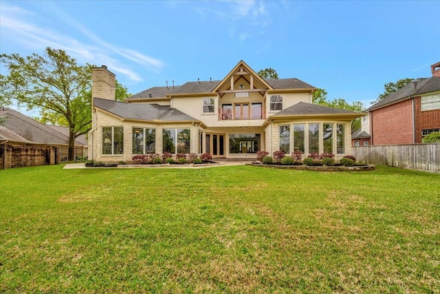 2023 Greenwood Oaks Dr, Houston, TX 77062 - rear view of property featuring a yard, stucco siding, a chimney, and a fenced backyard