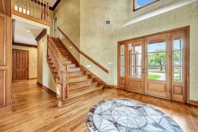 2023 Greenwood Oaks Dr, Houston, TX 77062 - entrance foyer featuring visible vents, crown molding, baseboards, stairway, and light wood-style flooring