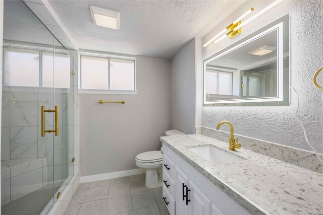 bathroom featuring toilet, a stall shower, a textured ceiling, and baseboards