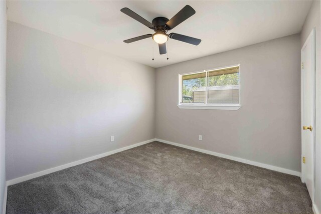 empty room with a ceiling fan, baseboards, and carpet floors