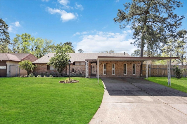 ranch-style house with an attached carport, a front yard, and fence