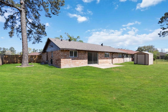 back of house with a storage shed, an outdoor structure, a yard, and a fenced backyard