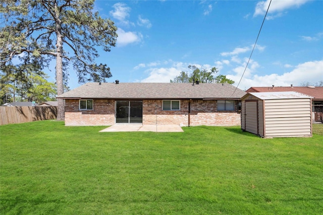 rear view of house with an outbuilding, a fenced backyard, a patio area, a storage shed, and a lawn