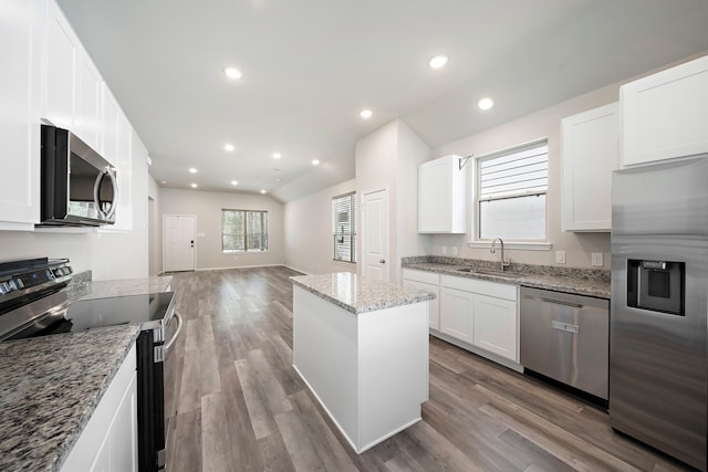 5899 Skylane Dr, Montgomery, TX 77316 - kitchen with stainless steel appliances, a sink, a center island, open floor plan, and wood finished floors