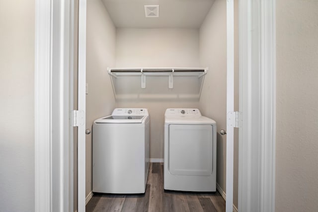 5899 Skylane Dr, Montgomery, TX 77316 - laundry area with washer and clothes dryer, dark wood-type flooring, and baseboards