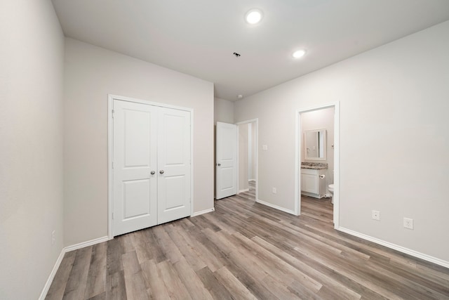5899 Skylane Dr, Montgomery, TX 77316 - unfurnished bedroom featuring light wood finished floors, baseboards, recessed lighting, a closet, and connected bathroom