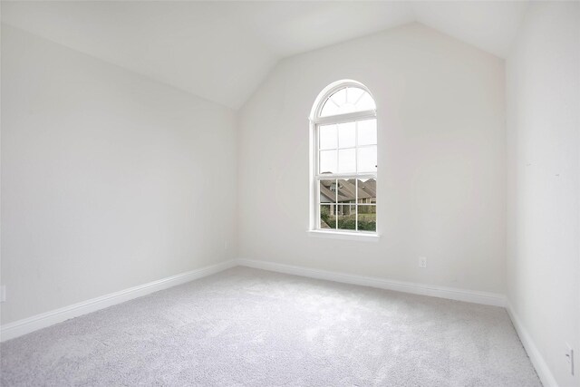 7611 Irby Cobb Blvd, Richmond, TX 77469 - spare room featuring carpet flooring, baseboards, and vaulted ceiling