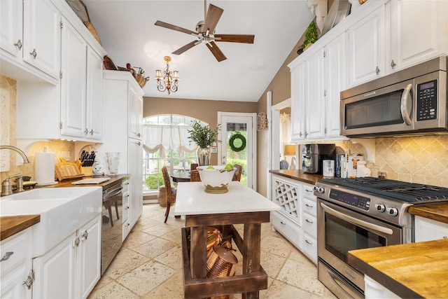 834 Lamonte Ln, Houston, TX 77018 - kitchen with butcher block countertops, appliances with stainless steel finishes, and white cabinetry