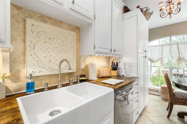 834 Lamonte Ln, Houston, TX 77018 - clothes washing area featuring a sink, stone tile flooring, a chandelier, and a healthy amount of sunlight