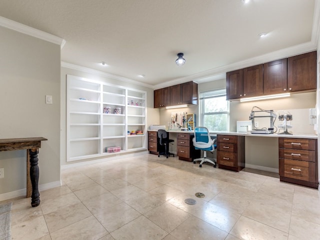 office area featuring light tile patterned floors, baseboards, built in desk, and crown molding