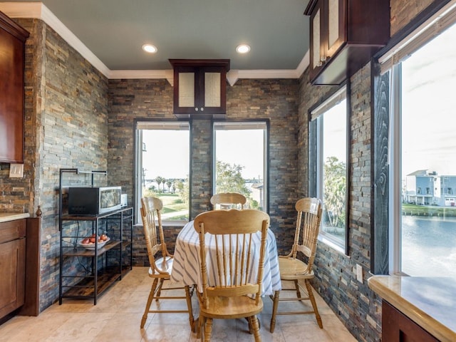 dining space featuring crown molding and recessed lighting
